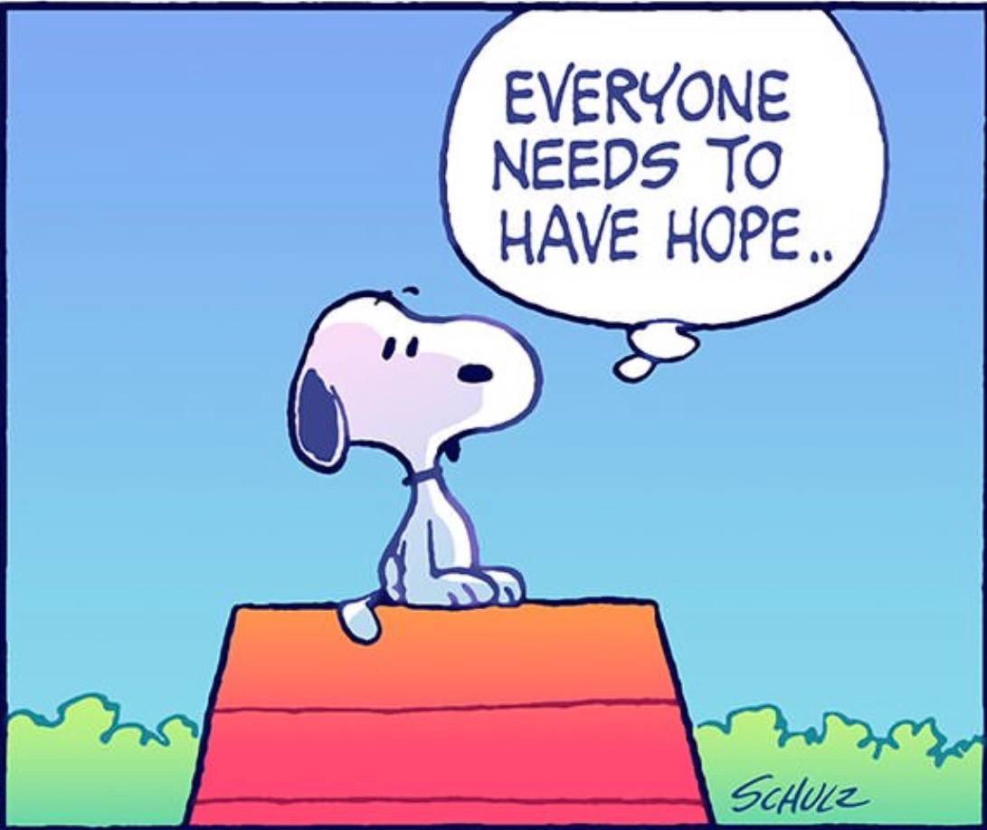 A girl with short black hair wearing glasses and an orange shirt